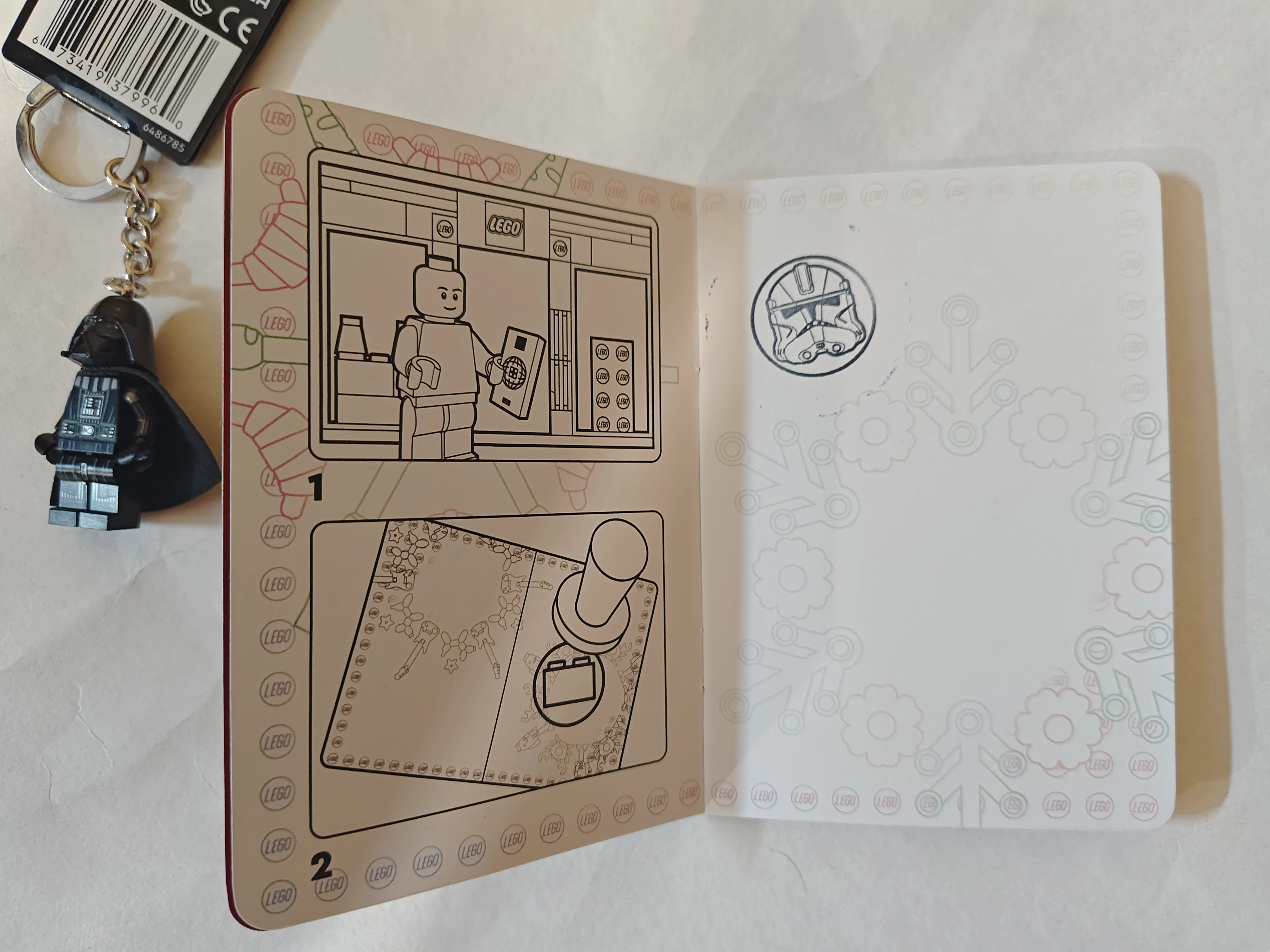 Lego passport open with Darth Vader keychain in background